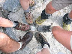 Six hikers' legs with hiking boots